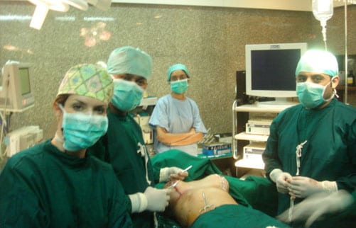 At the operating room table, after Dr. Walden has performed live aesthetic breast surgery for the Tutorials Conference
