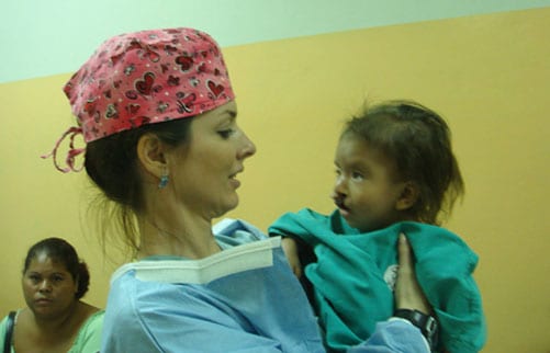 Dr. Walden with her patient with a bilateral cleft lip.